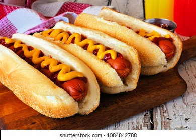 Traditional hot dogs with mustard and ketchup. Close up scene with wood background. - Powered by Shutterstock