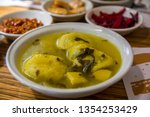 Traditional hot yellow Kubbe soup, a famous middle eastern dumplings soup dish, served in a bowl. Jerusalem, Israel. 