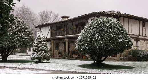 Traditional House In Avila, Spain, With Snow On The Roof And Floor. Winter Landscape.