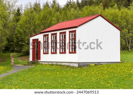Traditional house village in Skogar Open Air Museum, wooden facade Icelandic residential building with red roof.