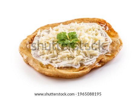 Traditional huangarian creamy langos with cheese, garlic and herbs