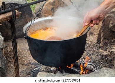 Traditional Hungarian bograch. Cooking on an open fire. Traditional Hungarian goulash in a cauldron. Transcarpathian dish. Soup with meat and chili pepper. - Shutterstock ID 2177389951
