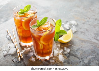 Traditional iced tea with lemon and ice in tall glasses - Shutterstock ID 657892990
