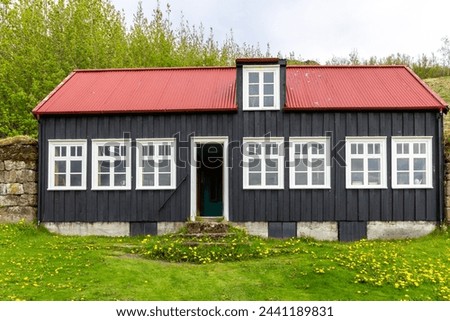 Traditional Icelandic schoolhouse from Litli-Hvammur, Myrdalur in Skogar Open Air Museum, black wooden facade building.