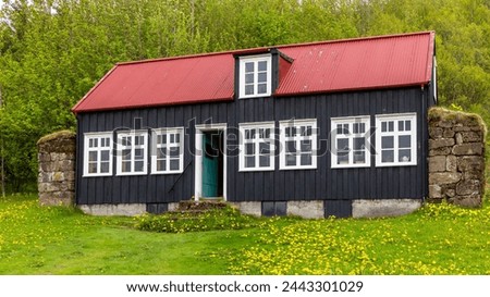 Traditional Icelandic schoolhouse from Litli-Hvammur, Myrdalur in Skogar Open Air Museum, black wooden facade building.