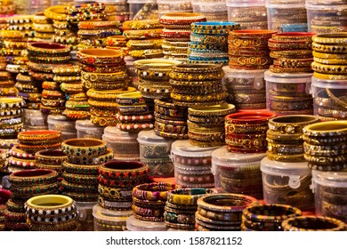 Traditional Indian Bangles And Bracelets At The Street Market In Jaipur, Rajasthan, India. Jewelry Made Of Gold-plated Metal With Multicolored Stones