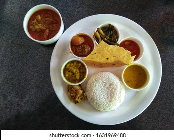 Traditional Indian Chicken Thali In A White Plate