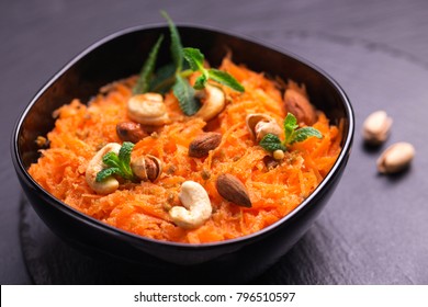 Traditional Indian Cuisine. Homemade Carrot Gajar Halwa On Black Slate Background. Copyspace, Horizontal View, Flatlay