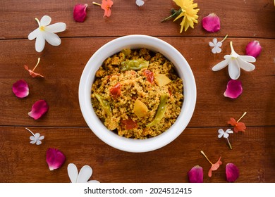 Traditional Indian fasting food recipe dish called Bhagar homemade of Barnyad millet rice grains. Also known as samo or sama pulao rice khichdi. Indian fasting food dish on wooden background - Shutterstock ID 2024512415