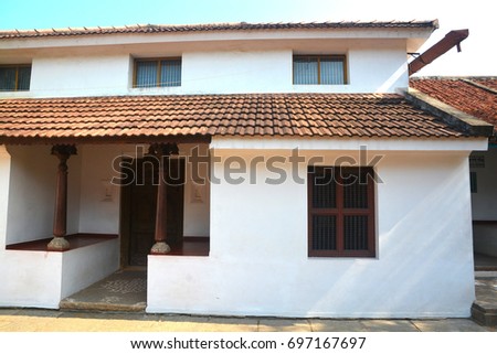 Traditional Indian house with brick roofs and wooden pillars.