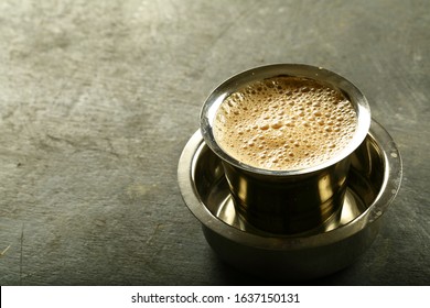 Traditional Indian kumbhakonam,kumbakonam filter coffee with foam in steel cup.