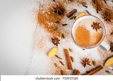 Traditional indian masala chai tea with spices - cinnamon, cardamom, anise, white background. Top view copy space