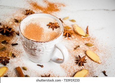 Traditional indian masala chai tea with spices - cinnamon, cardamom, anise, white background. Copy space