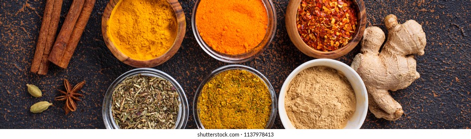 Traditional Indian spices. Turmeric, chili pepper, curry, ginger, dry herbs and saffron. Banner for design site