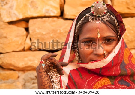 Traditional Indian woman in sari costume covered her face with veil, India