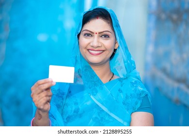 Traditional Indian Woman Showing Blank White Debit Credit Bank Card Mockup, Happy Female Wearing Sari Holding Empty Business Or Electronic Card For Payment.