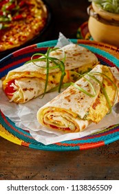 Traditional Indigenous Ugandan Rolex Rolls, A Popular Street Food Made With Chapati, Egg Omelette And Fresh Vegetables Served On A Colourful Basket