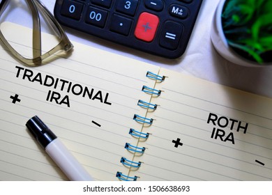 Traditional IRA And Roth IRA Text On A Book Isolated On Office Desk.
