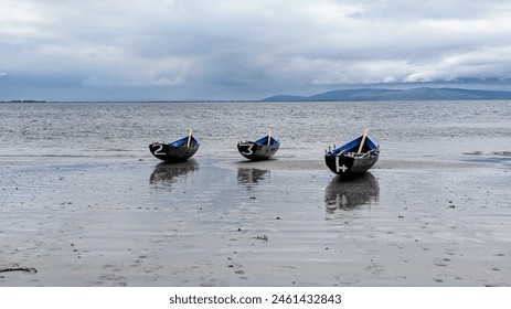 Traditional Irish Currach wooden boats on Salthill beach ready for racing, nature and seascape background, Galway, Ireland - Powered by Shutterstock