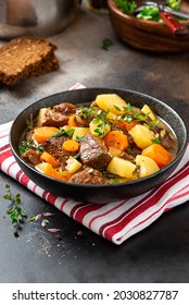 Traditional Irish stew in a black bowl on a dark background. Stew of lamb, potatoes, onions, carrots, and thyme. Traditional dish of St. Patrick's Day. - Shutterstock ID 2030827787