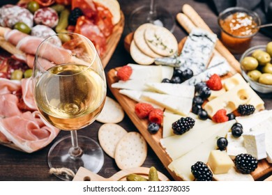 Traditional Italian appetizers antipasti : salami, bresaola, prosciutto, olives. Aperitif in Italy in Florence, Rome, aperitif in Milan. Two glasses of Prosecco and sticks of cereal bread