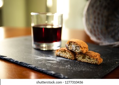 Traditional italian biscuits "Cantucci" with glass of red wine. Typical tuscan food