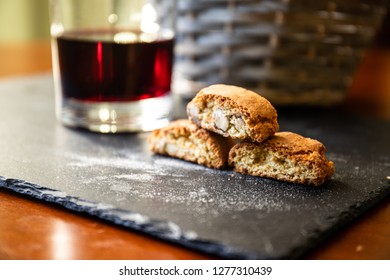 Traditional italian biscuits "Cantucci" with glass of red wine. Typical tuscan food