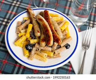 Traditional Italian Creamy Rigatoni Pasta With Olives And Fried Spicy Chicken Sausages..