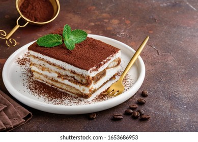 Traditional italian dessert tiramisu on a white plate. Copy space. Selective focus