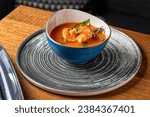 Traditional italian fish soup with shrimp, mussels and salmon. Tom yam kung with seafood. Healthy food, close-up. Serving food in a restaurant
