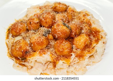 Traditional italian pasta with meatballs and parmesan, polpette and fettuccine in red tomato sauce. - Shutterstock ID 2118354551
