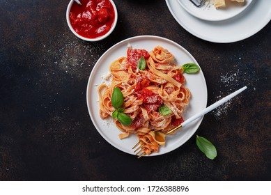 Traditional italian pasta with tomato, basil and parmesan. Top view image with a copy space