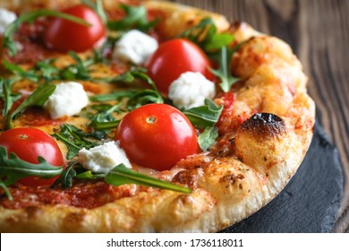 Traditional italian pizza on a rustic background close-up. - Powered by Shutterstock