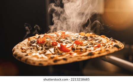 traditional italian pizza from the stone oven with fresh steam in the italian pizzeria - Powered by Shutterstock