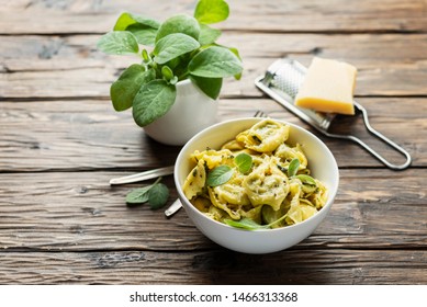 Traditional italian raviolli with sage and ricotta, rstic style and selective focus