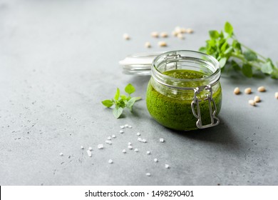 Traditional italian sauce pesto with green basil on grey background  - Powered by Shutterstock