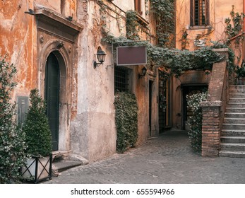 Traditional Italian Street With Staircase And Ivy Walls