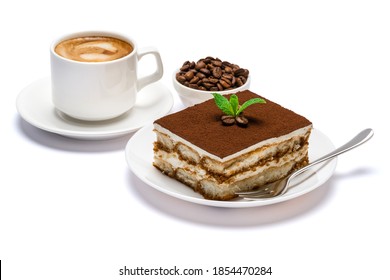 Traditional Italian Tiramisu dessert square portion on ceramic plate and cup of fresh espresso coffee isolated on white background with clipping path