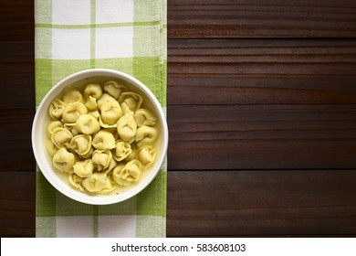 Traditional Italian Tortellini In Brodo (broth) Soup, Photographed Overhead On Dark Wood With Natural Light 