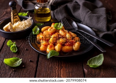 Traditional Italina potato gnocchi served with tomato sauce, cheese and fresch basil