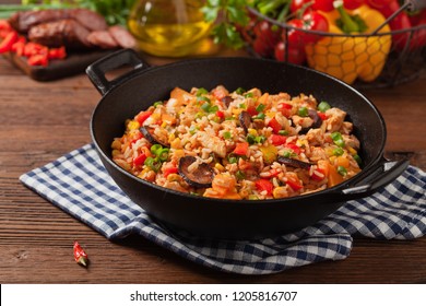 Traditional jambalaya perepared in wok, serwed on plate. Front view.