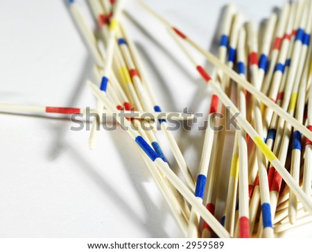 Traditional Japanese Board Game "Mikado". Bamboo sticks from the game on a white background . Top view, macro.