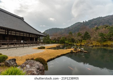 Traditional Japanese Building In Front Of A Zen Garden With A Pond