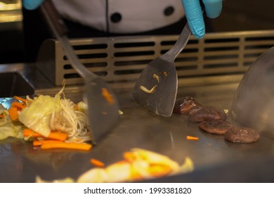 Traditional Japanese Cooking In A Flat Pan Prepared By The Chef In Front Of The Customer. (Teppanyaki)