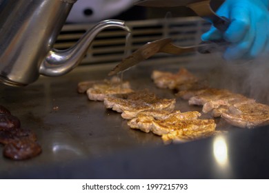 Traditional Japanese Cooking In A Flat Pan Prepared By The Chef In Front Of The Customer. (Teppanyaki)