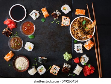 Traditional Japanese Food - Sushi, Rolls, Rice With Shrimp And Sauce On A Dark Background. Top View