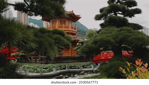 Traditional Japanese garden with wooden pagoda, vibrant red bridge, lush greenery, and cityscape in background. Serene landscape blending nature with architecture. Outdoor zen garden scene. - Powered by Shutterstock