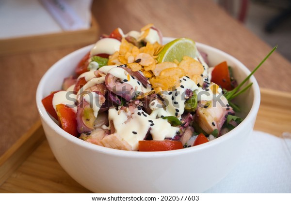 Traditional Japanese healthy food - poke bowl - is\
made of super cold tuna or fish served over warm sushi rice, brown\
or black rice