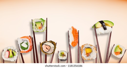Traditional japanese sushi pieces placed between chopsticks, separated on pastel background. Very high resolution image.