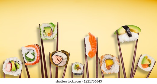 Traditional japanese sushi pieces placed between chopsticks, separated on pastel background. Very high resolution image.